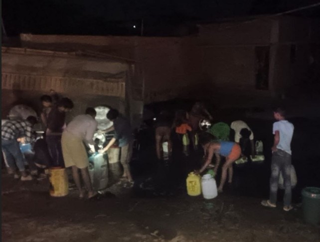 People arrived in Mauganj with buckets and cans to loot diesel