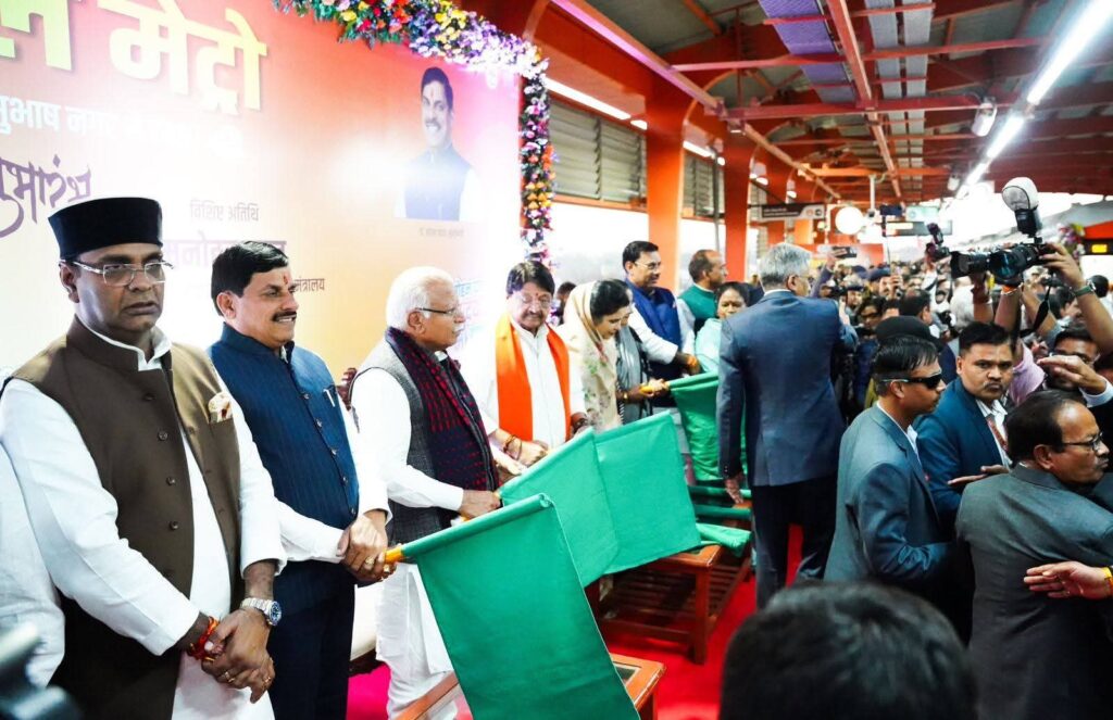 Bhopal Metro train operating on an elevated track with cityscape views and passengers at a newly built station.