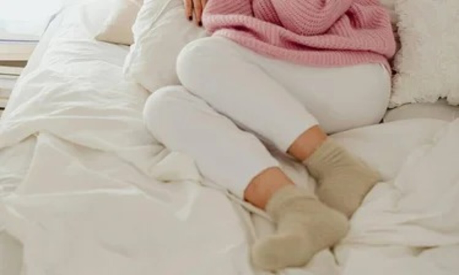 A person sleeping comfortably in winter while wearing warm socks to protect feet from cold