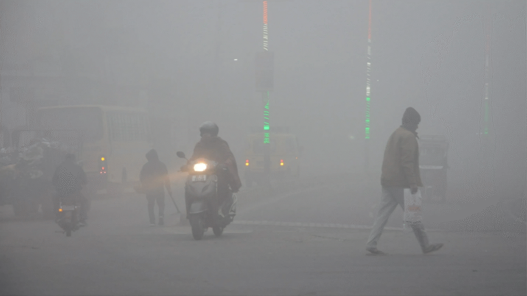 Thick fog on a road in Uttar Pradesh as vehicles move slowly amid low visibility conditions