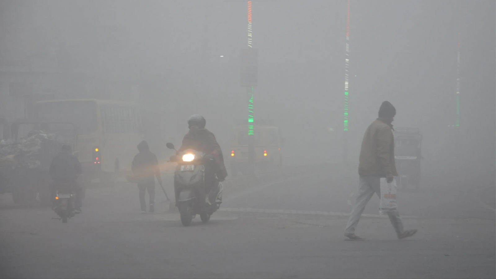 Thick fog on a road in Uttar Pradesh as vehicles move slowly amid low visibility conditions