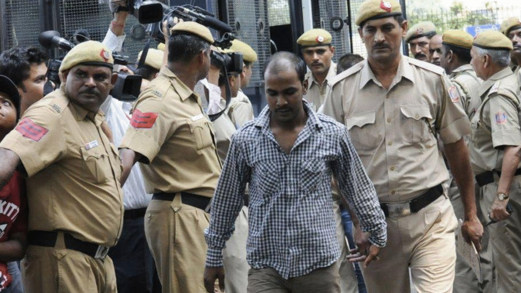 Police escorting an accused during court proceedings in a gangrape case