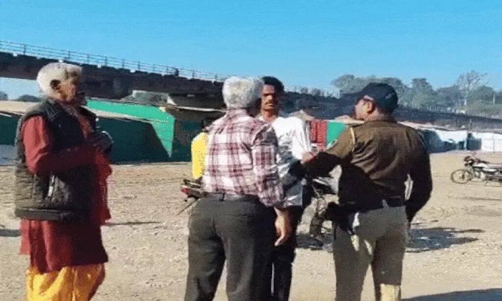 People confront an administrative officer during an alleged altercation in Madhya Pradesh