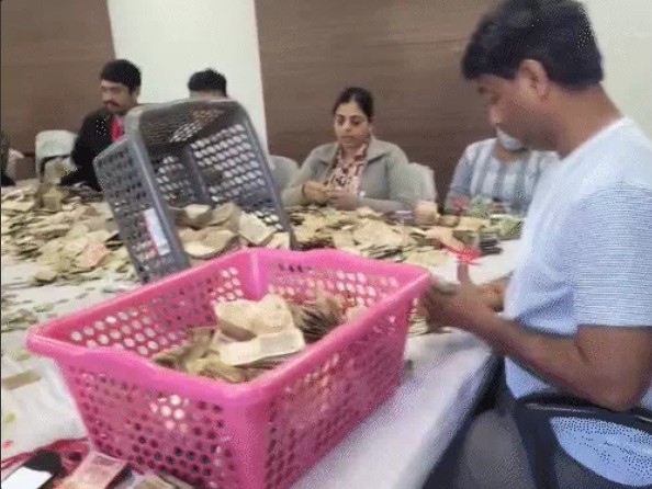 Officials counting cash and valuables recovered from donation boxes at Khajrana Temple in Indore