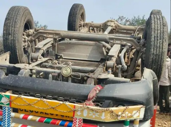 Overturned pickup vehicle after road accident in Maihar, with locals gathered at the crash site