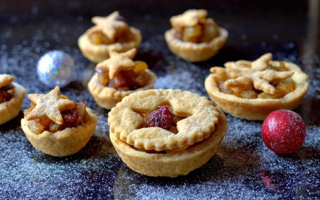 Freshly baked Christmas mince pies filled with dry fruits, served as a festive dessert.