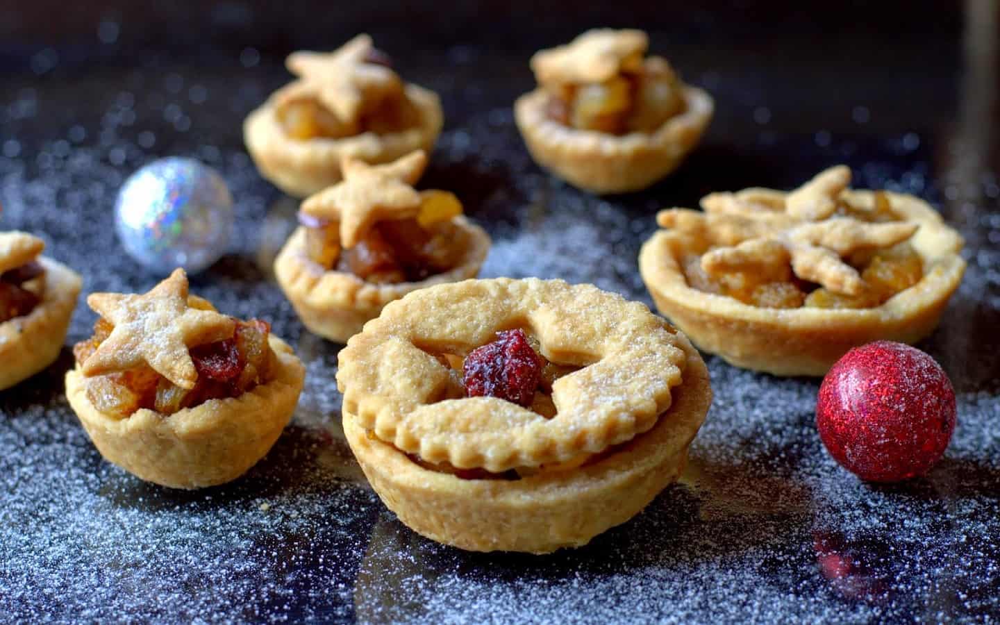 Freshly baked Christmas mince pies filled with dry fruits, served as a festive dessert.
