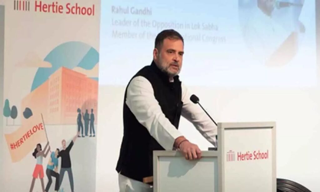 Rahul Gandhi addressing an audience during an overseas event, speaking from a podium.