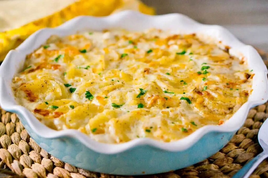 Creamy scalloped potatoes baked with cheese served as a Christmas side dish