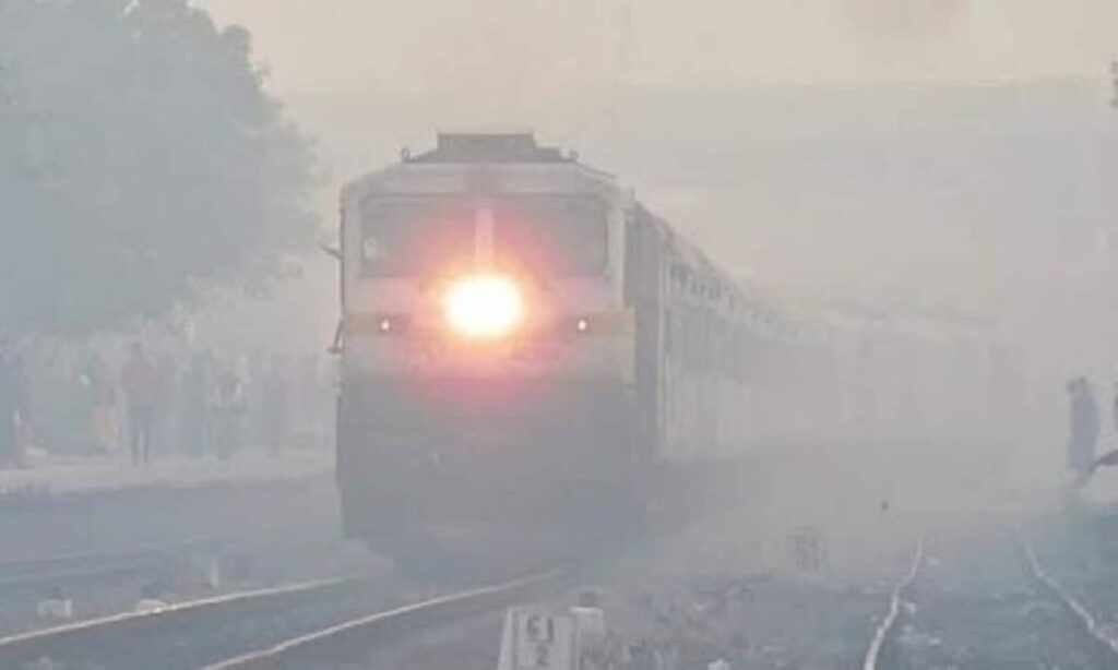Train approaching railway track in dense fog affecting rail traffic in North India