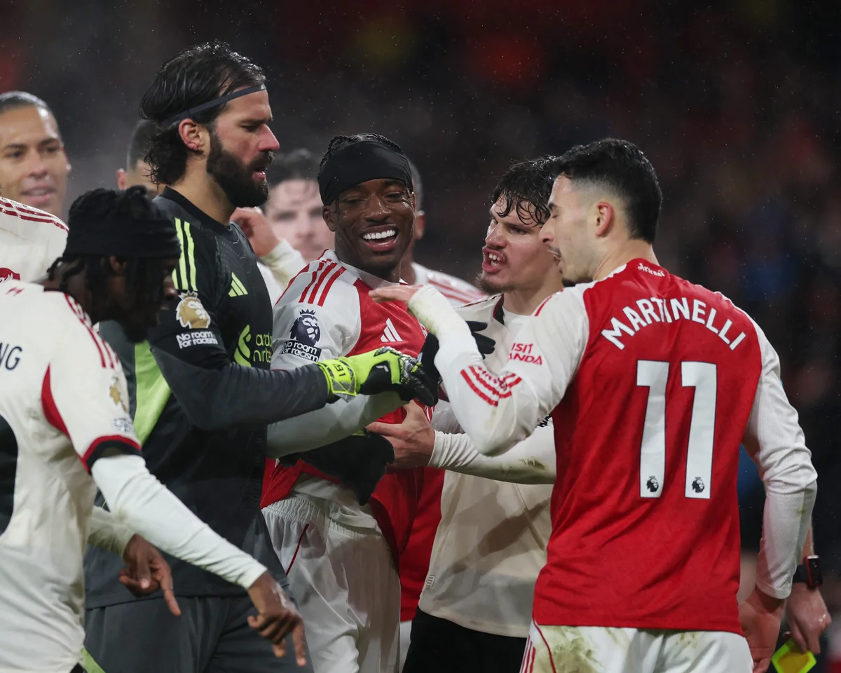 Arsenal and Liverpool players reacting during a tense Premier League match at Emirates Stadium