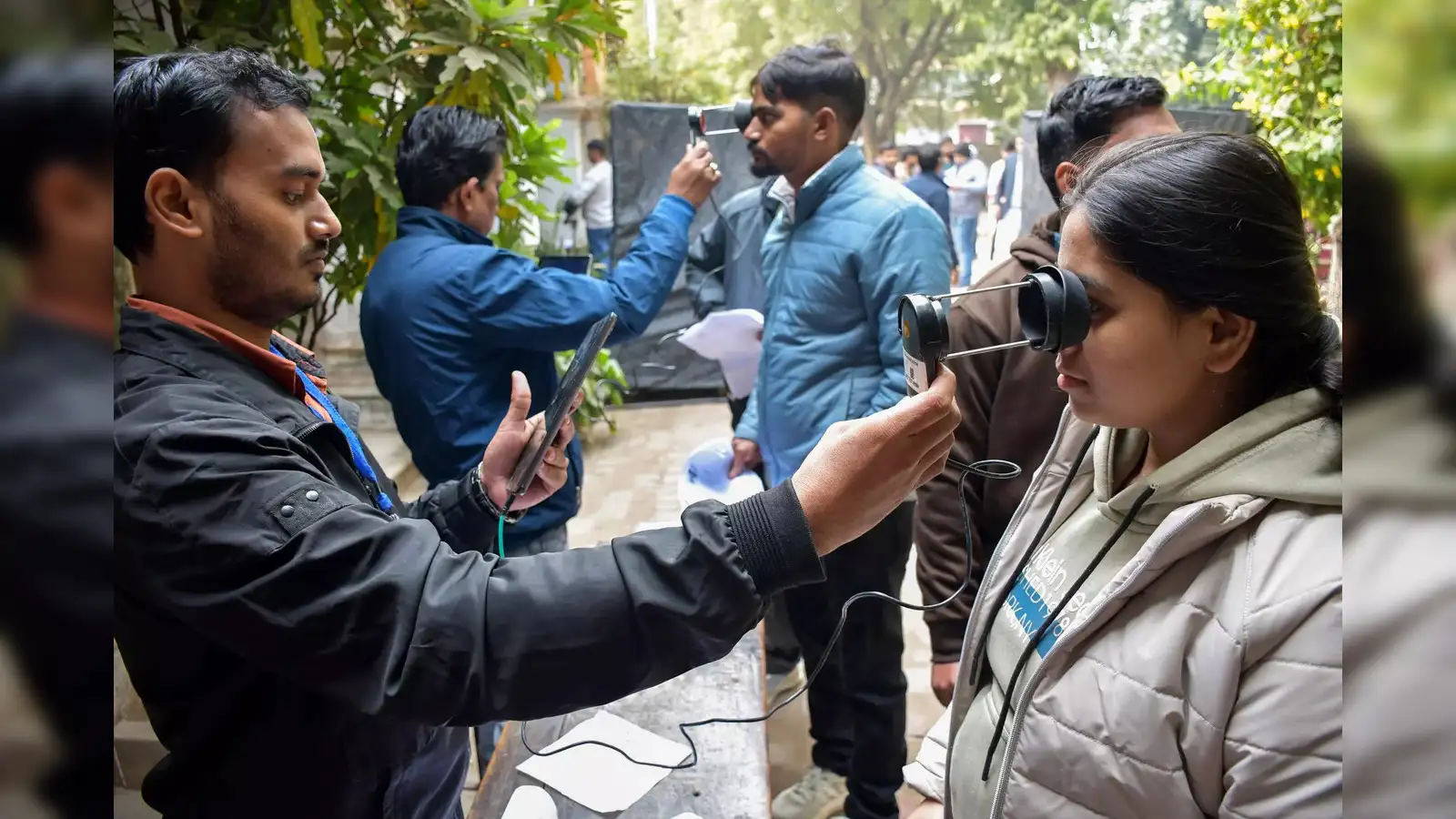 Students undergoing facial biometric verification at an exam centre during identity checks in India