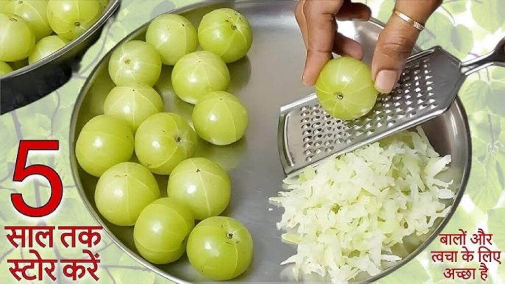 Fresh amla being grated and prepared for homemade murabba in a kitchen bowl
