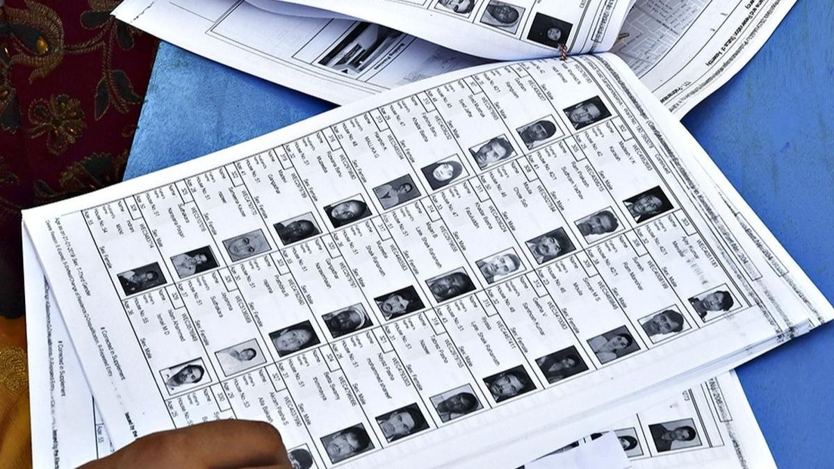 Election officials in Assam verifying names on the printed final voter list 2026.