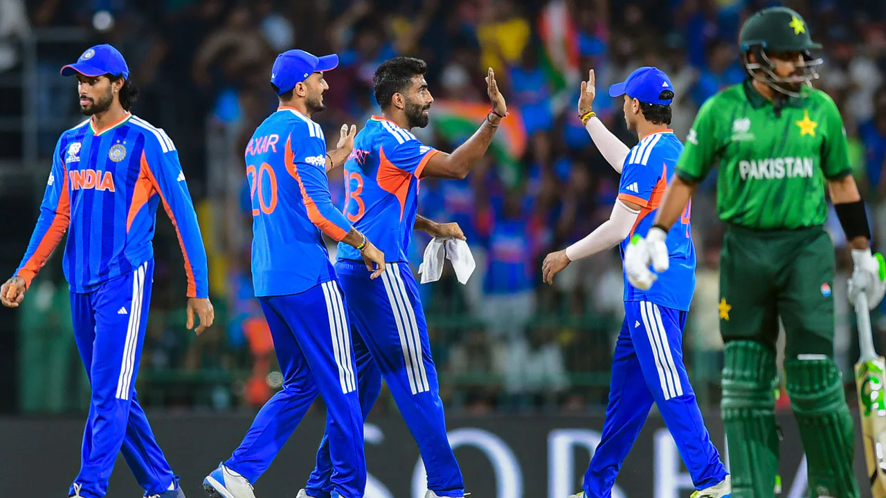 Indian cricket players celebrating victory while Pakistan batter walks back dejected during T20 World Cup match.