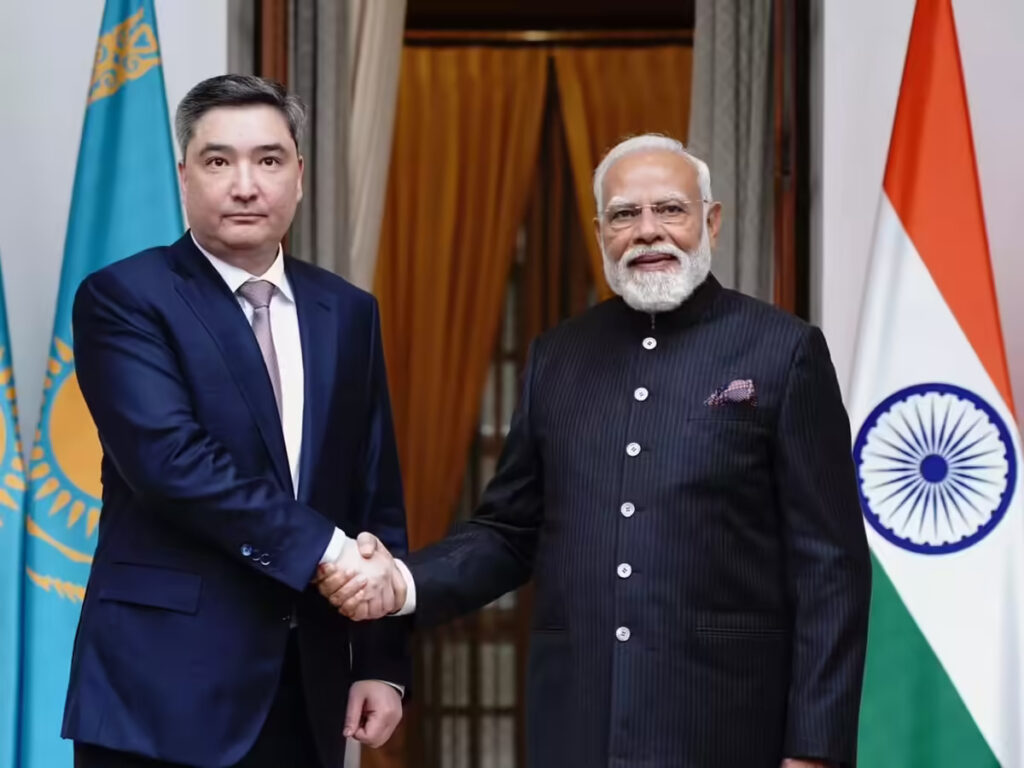 PM Narendra Modi and Kazakhstan PM Olzhas Bektenov shaking hands at the AI Impact Summit 2026 in New Delhi