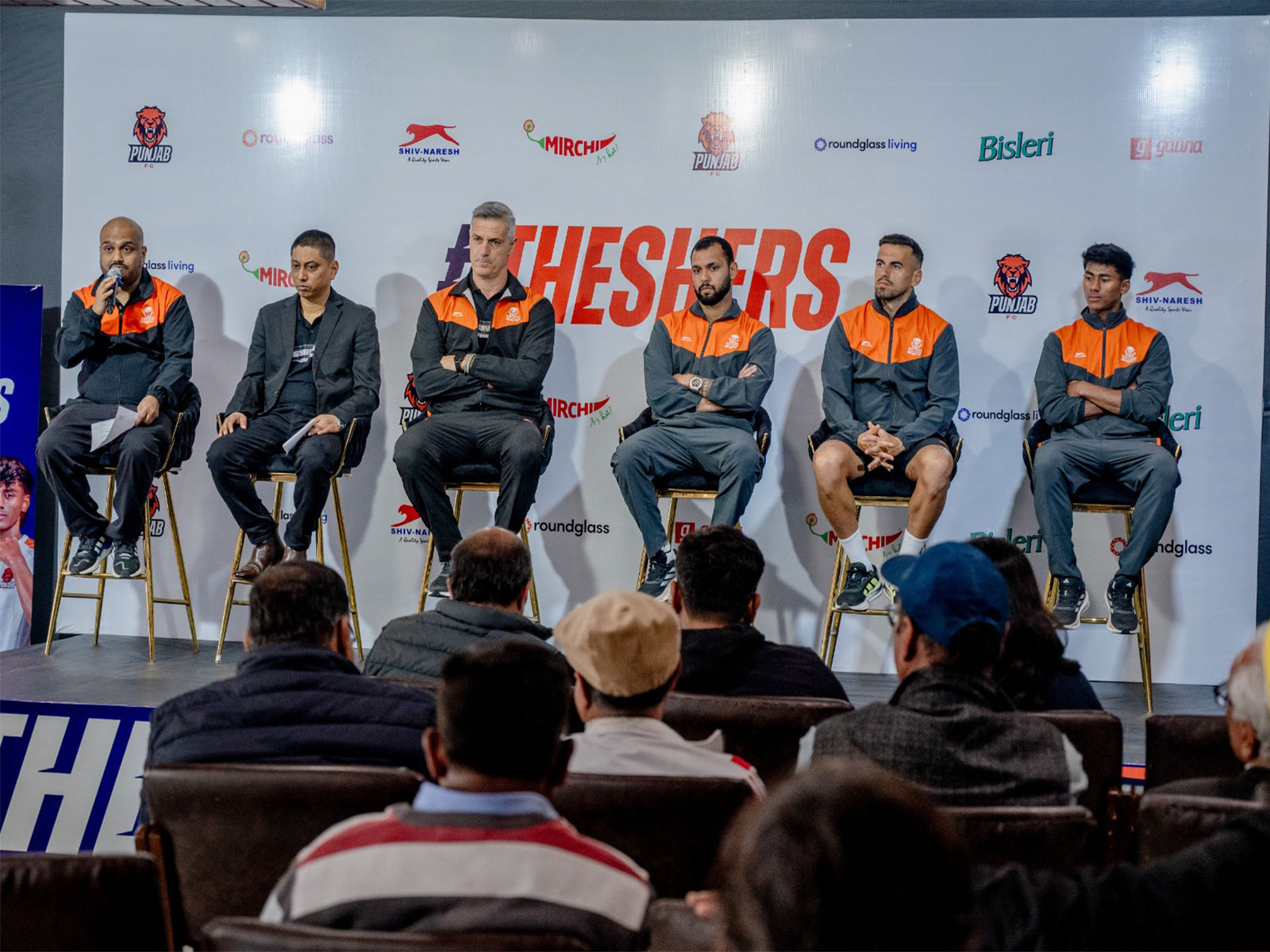 Punjab FC officials and players at the ISL 2025-26 squad announcement press conference.