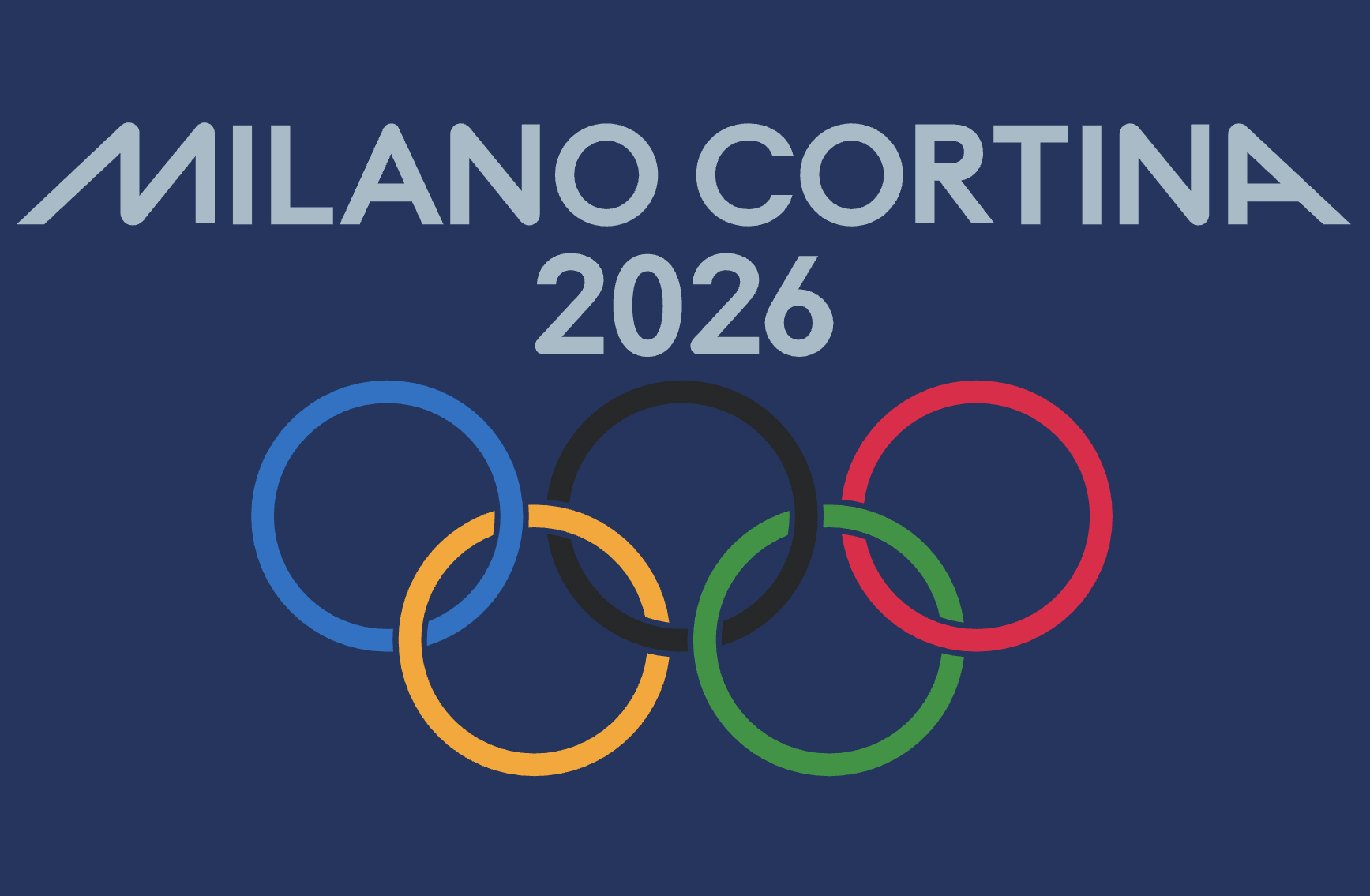 The Olympic rings displayed against a snowy mountain backdrop in a European alpine village setting.