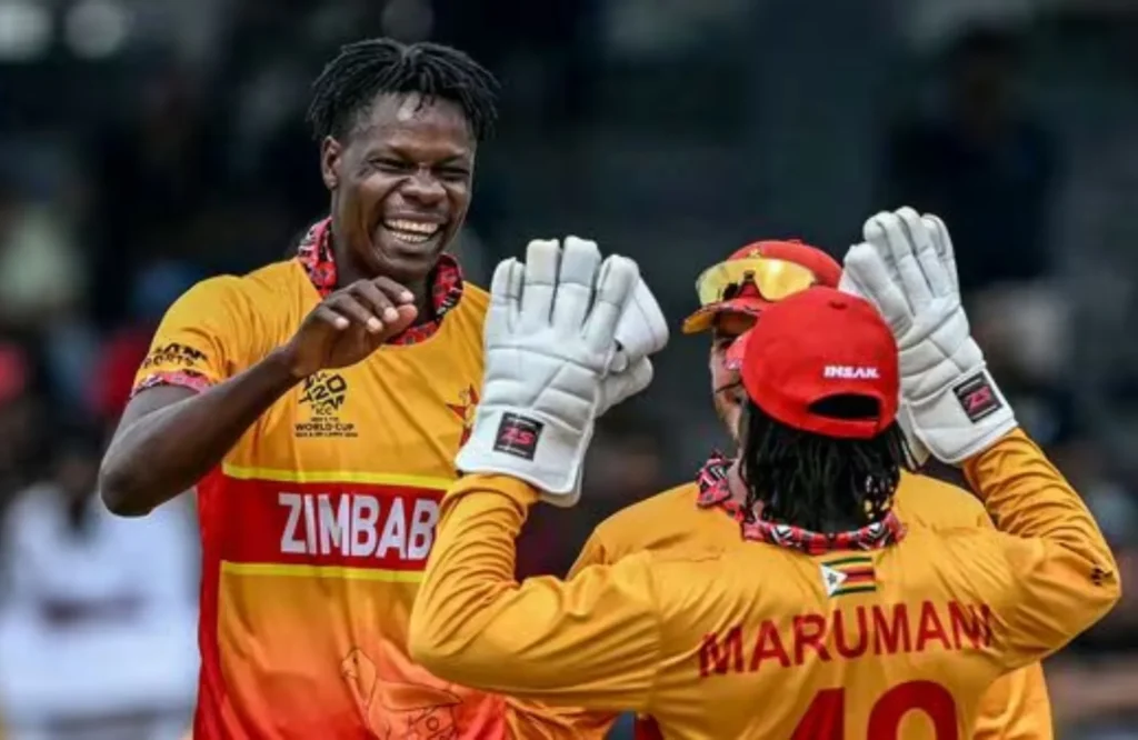 Zimbabwe cricketers Taddy Marumani and teammates celebrating on field after qualifying for T20WC Super Eight.