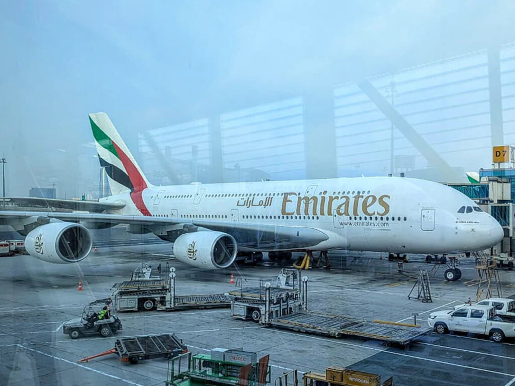 Emirates passenger plane parked at Kerala airport following a mid-flight diversion due to a Dubai Airport drone strike.