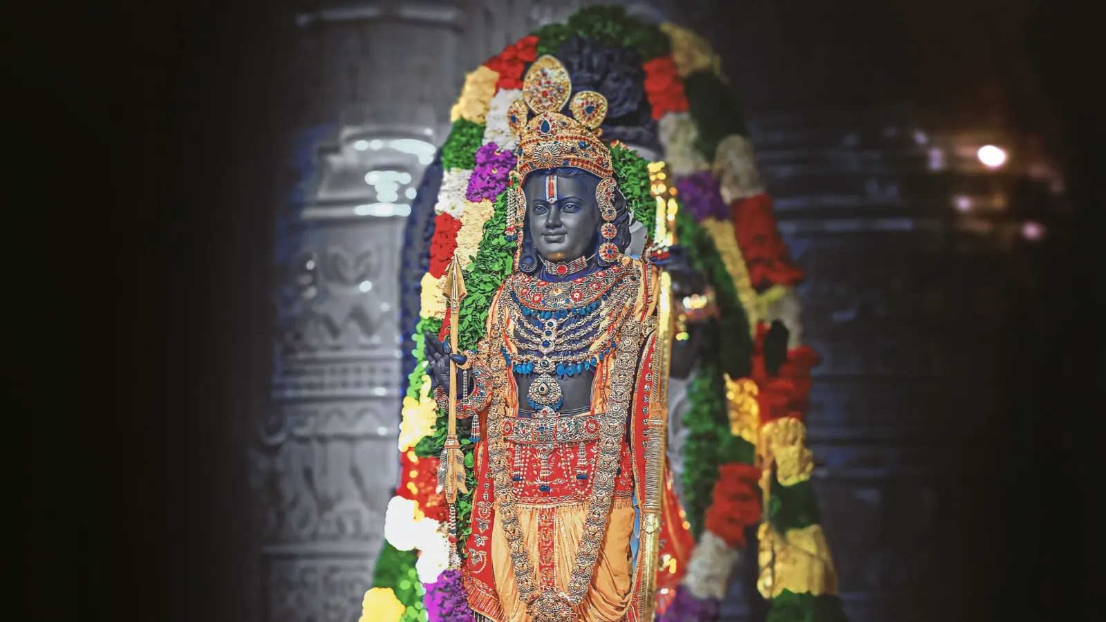 Devotees offering prayers and yellow flowers to Lord Rama idols during Ram Navami 2026 celebrations in India.