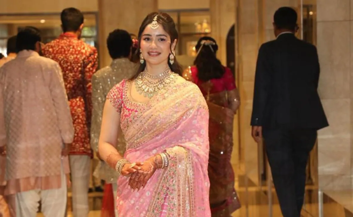 Tendulkar posing in a pink Manish Malhotra saree and traditional jewellery at Arjun Tendulkar's wedding in India.