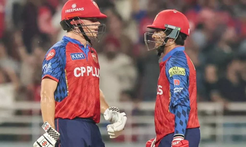 Cooper Connolly and Arya discussing batting strategy on the cricket field