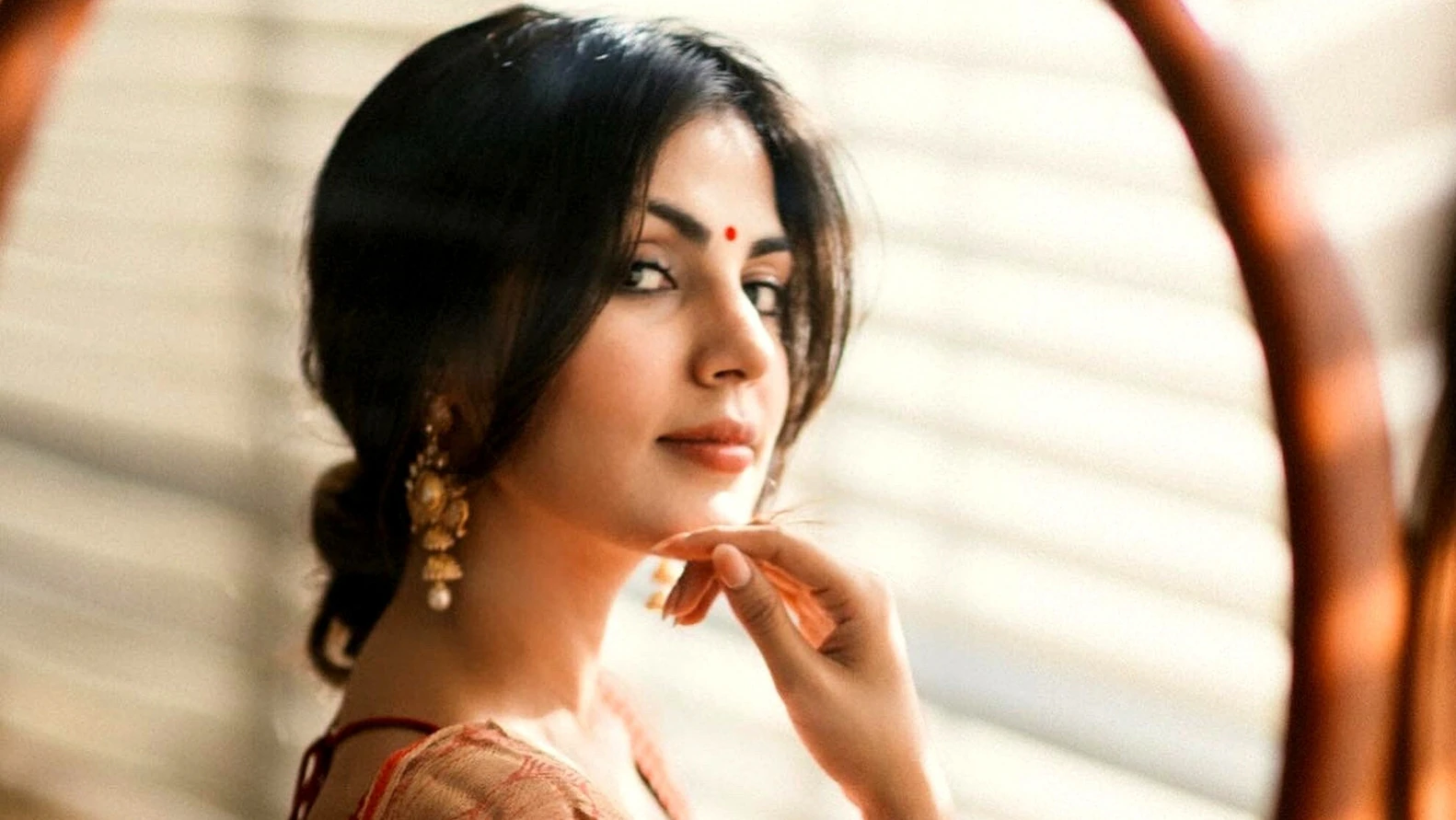 Rhea Chakraborty wearing a traditional red and white Bengali saree for Poila Boishakh 2026.