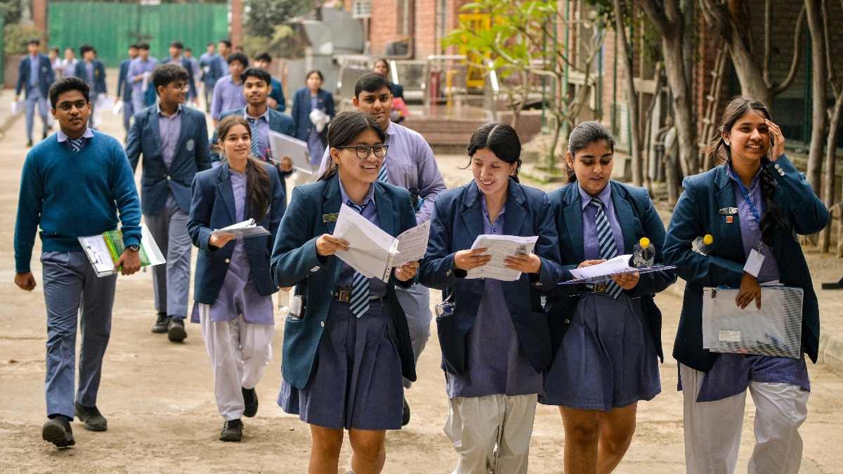 Students checking CBSE Class 12 Result 2026 on laptop and mobile devices.