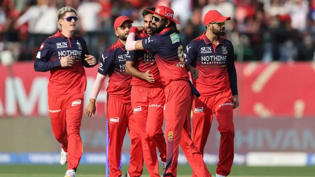 RCB players celebrating their victory and playoff qualification against Punjab Kings in IPL 2026.
