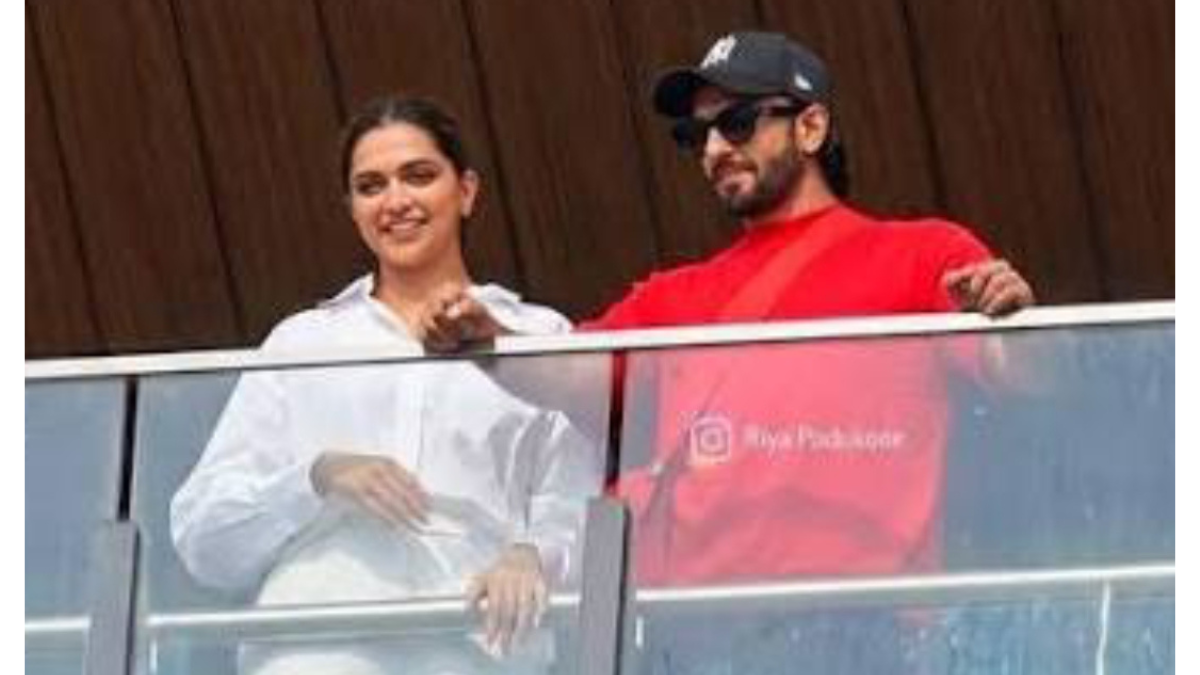 Deepika Padukone's baby bump spotted; actress seen with Ranveer on the balcony of their new home.