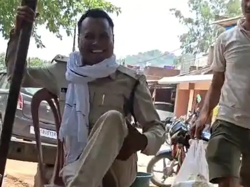 Deputy Ranger creates a ruckus after climbing onto a pushcart at a main intersection in Singrauli.