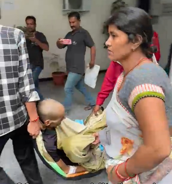 Wife arrives at the Collectorate carrying her cancer-stricken husband in a makeshift sling.